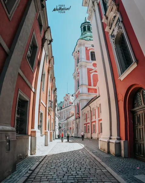 Tourists enjoying a free walking tour in Krakow's Old Town.