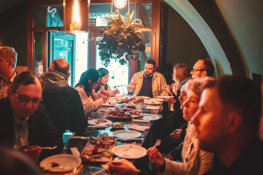 A group of tourists enjoying a food tour in Krakow, Poland.