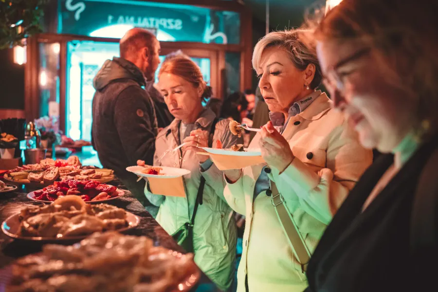 Tourists enjoying a delicious food tour in Krakow, Poland.