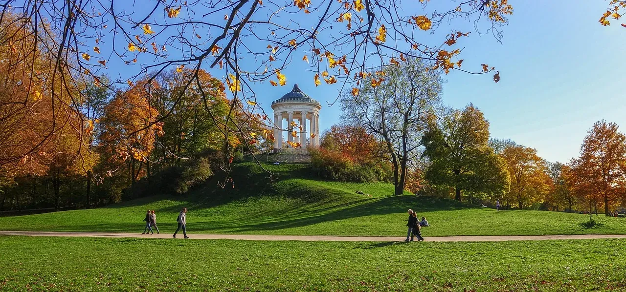 Autumn in Munich's English Garden: Visitors stroll past the iconic Monopteros.