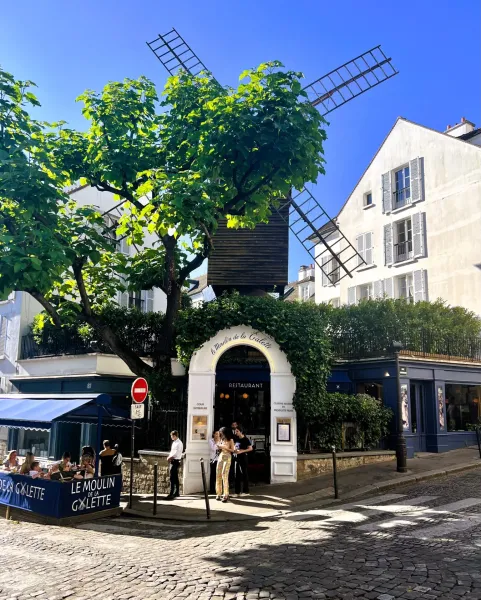 Le Moulin de la Galette restaurant in Montmartre, Paris, with its iconic windmill.