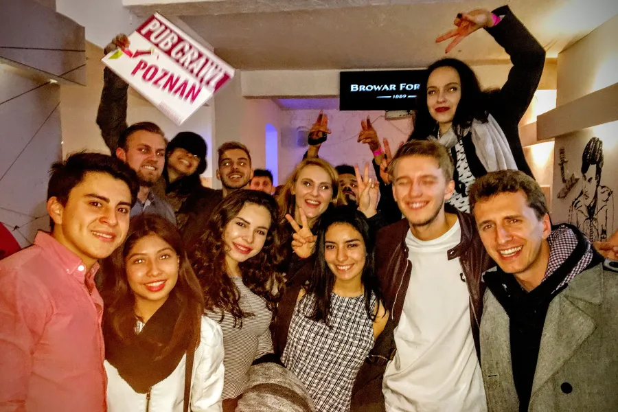 Happy tour group enjoying a pub crawl in Poznan, Poland.