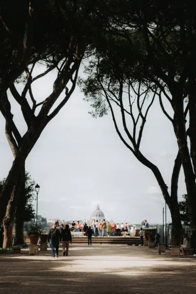 Tourists enjoying a view of St. Peter's Basilica in Rome.