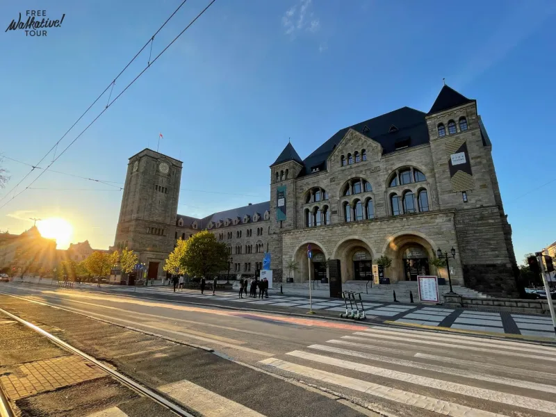 Tourists enjoying a free Walkative! tour in Wrocław, Poland, admiring the Wrocław University of Science and Technology.