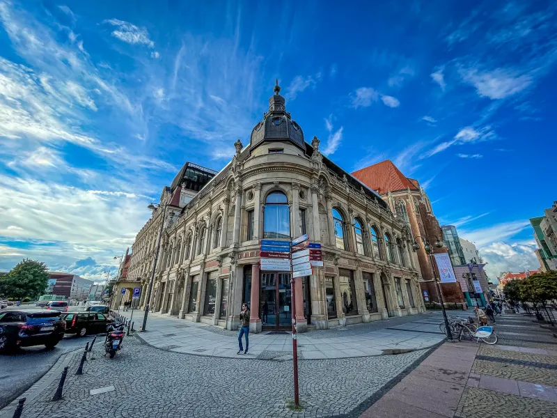 A beautiful building in Wroclaw, Poland, under a bright blue sky.
