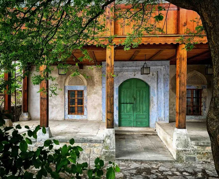 Serene entrance to a historical building with a vibrant green door.