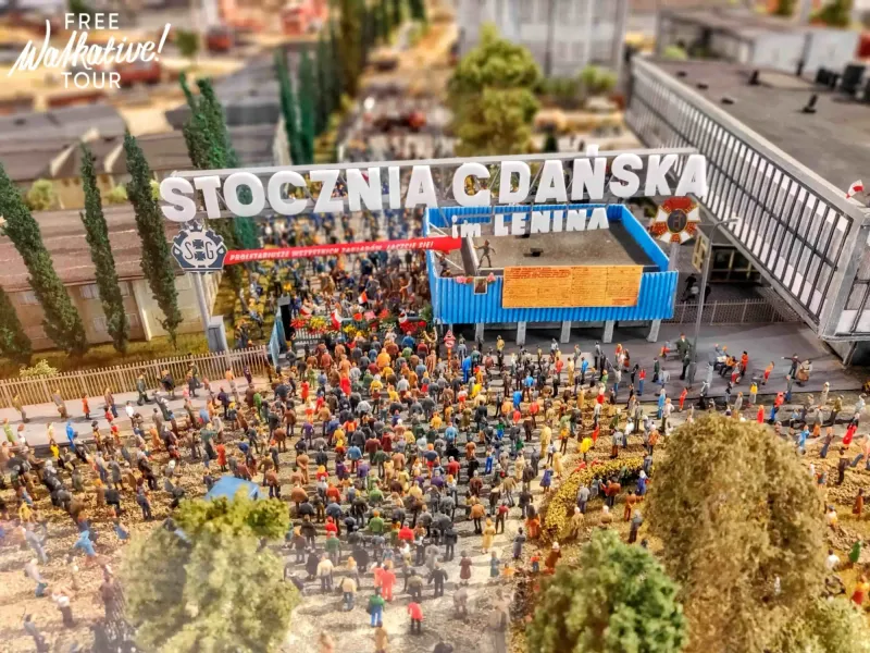 Miniature model of the Gdańsk Shipyard, showing a large crowd of people gathered under a sign "STOCZNIA GDAŃSKA im. LENINA".