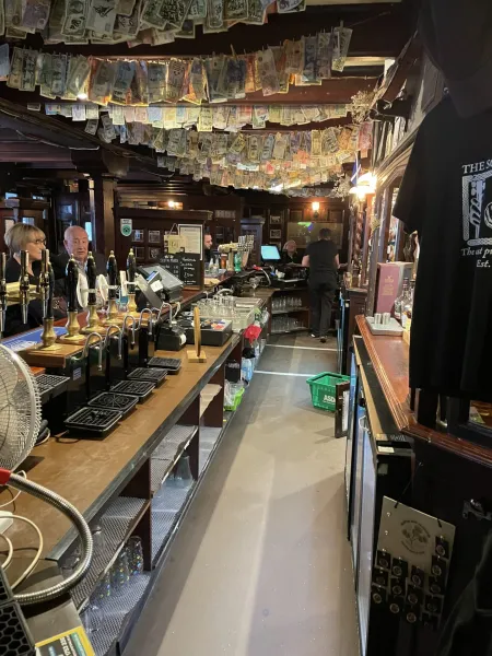 Interior of a pub with currency decorations.