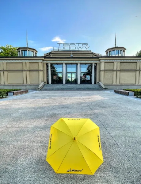 A yellow Walkative umbrella on the plaza in front of the Teatr Ludowy (People's Theatre) in Krakow's Nowa Huta district.