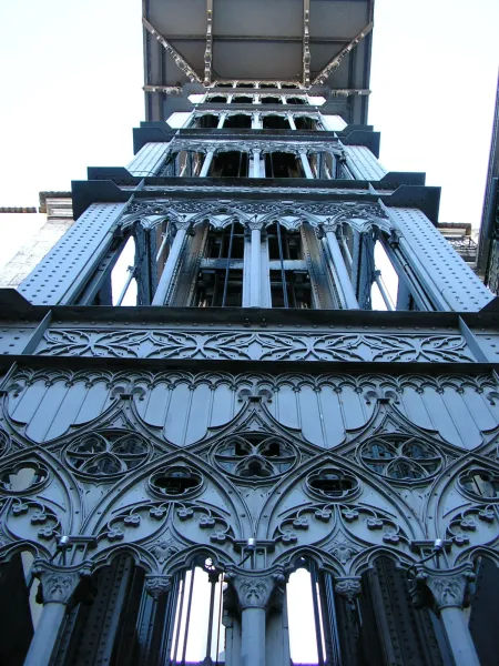 Looking up at the ornate neo-Gothic ironwork of the Santa Justa Lift in Lisbon.