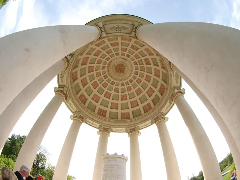 Interior view of the Monopteros rotunda in Munich's Englischer Garten, showing its classical dome ceiling with ornate patt...