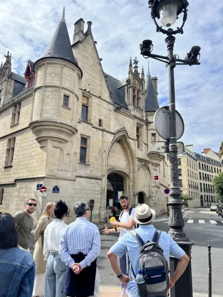 A guided tour group in Paris, France, admiring the Hôtel de Sens.