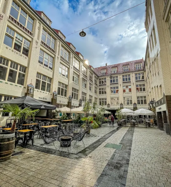 Picturesque courtyard in Wrocław, Poland, with cafes and restaurants.