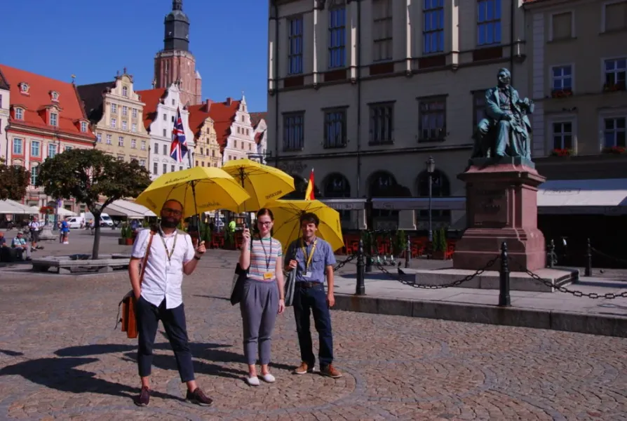 Wroclaw walking tour group with yellow umbrellas.