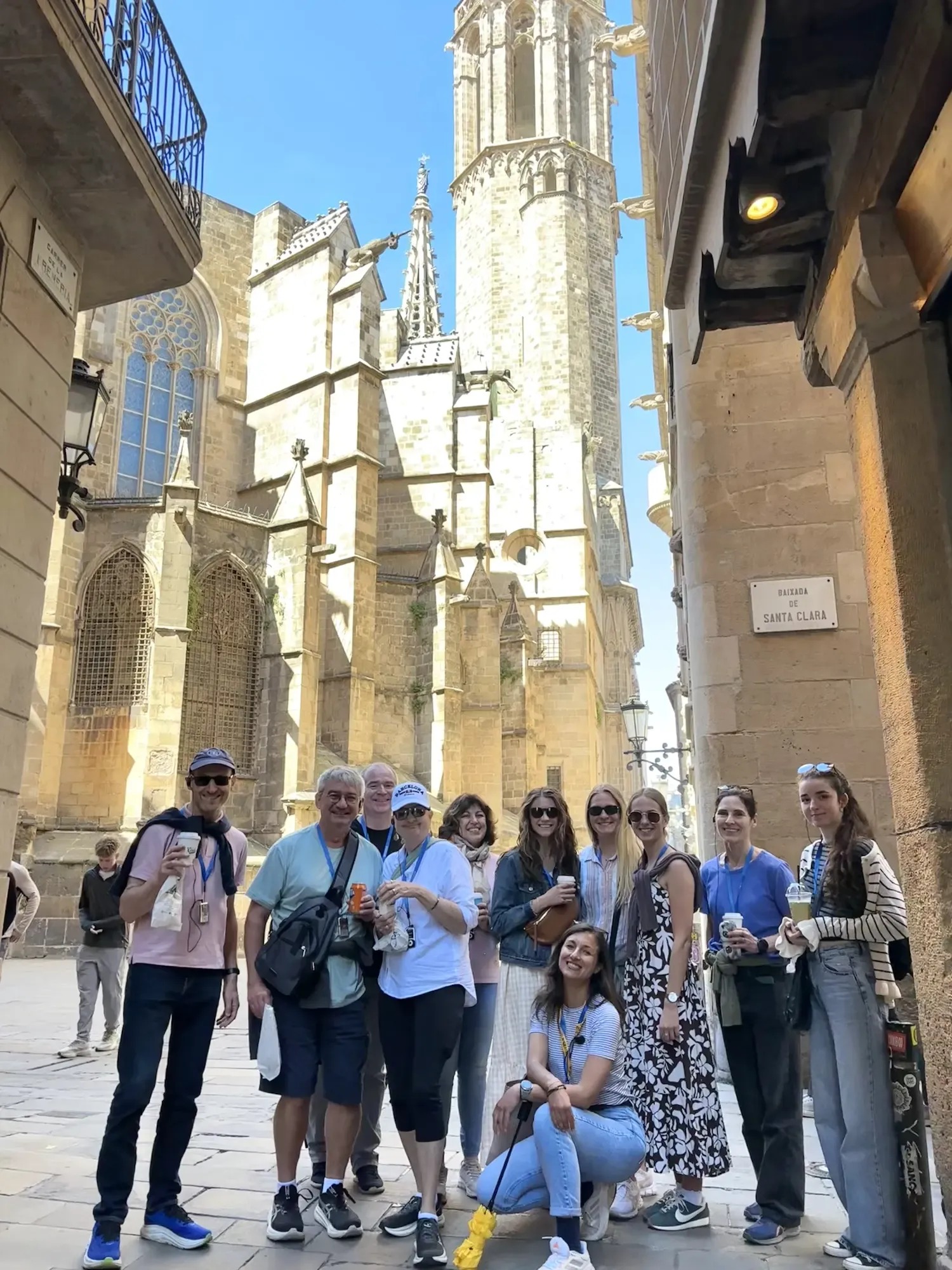Barcelona Cathedral at dusk, tourists admiring the Gothic architecture.