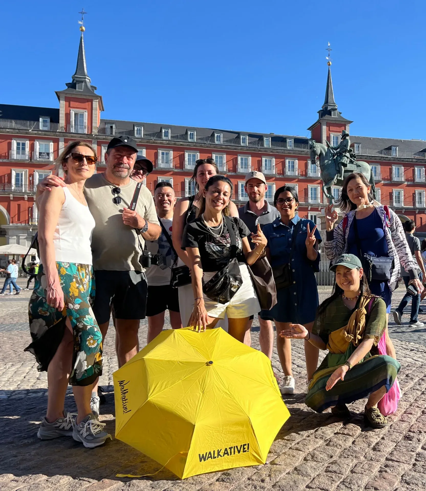 Happy tourists on a WALKATIVE! tour in Madrid's Plaza Mayor.